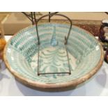 A large Continental slip ware pottery bowl, the interior decorated with green wavy lines, the base