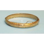 A 9ct gold hinged bangle, 10.2g.