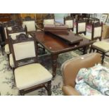 An Edwardian mahogany extending dining table on four turned legs, with two leaves and handle, 180