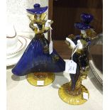 A pair of Murano figures of dancers decorated in blue and amber glass, on circular bases, 30cm high,