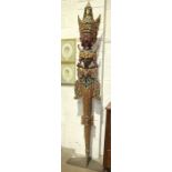 A large Asian carved and painted wood totem in the form of a female figure, the lower half in the