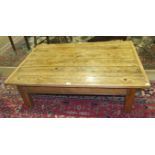 A low pine plank-top coffee table on square legs, 125.5 x 85cm.