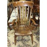 A stained elm and beech lathe-back farmhouse chair on turned legs and H-stretcher, (needs re-