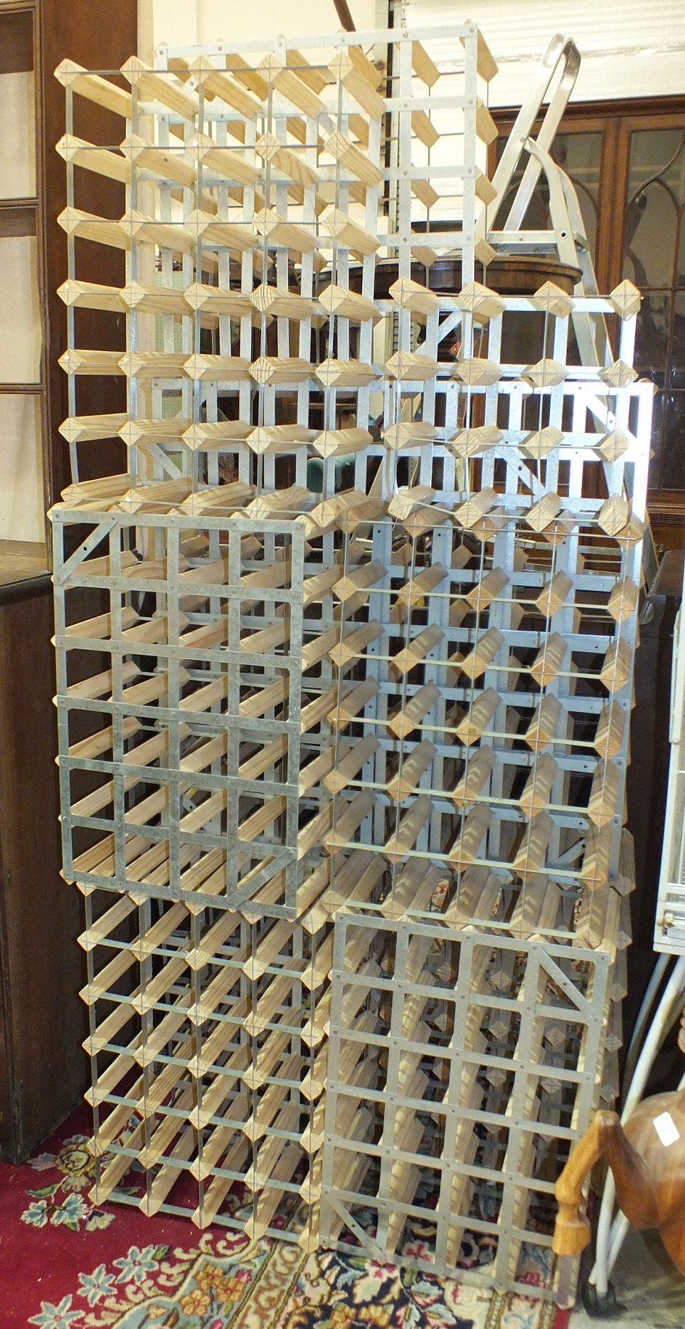 A collection of nine modern galvanised metal and wood wine racks, various sizes.