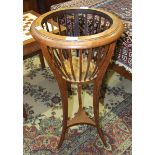 An Edwardian oak basket jardinière stand on three splayed supports united by an undertier, 37cm