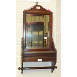 An Edwardian mahogany bathroom wall mirror, the plate above a hinged rectangular compartment and