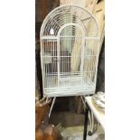 A metal-framed bird cage with hinged entrance door and domed roof, on stand, 55.5cm wide, 151.5cm