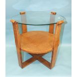 A 1950's/1960's oak circular occasional table with plate glass top, the supports joined by an