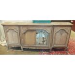 A walnut sideboard in the French taste, the shaped rectangular top above a pair of mirrored