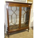 An Edwardian mahogany bookcase, the rectangular top above a pair of astragal-glazed doors, on base