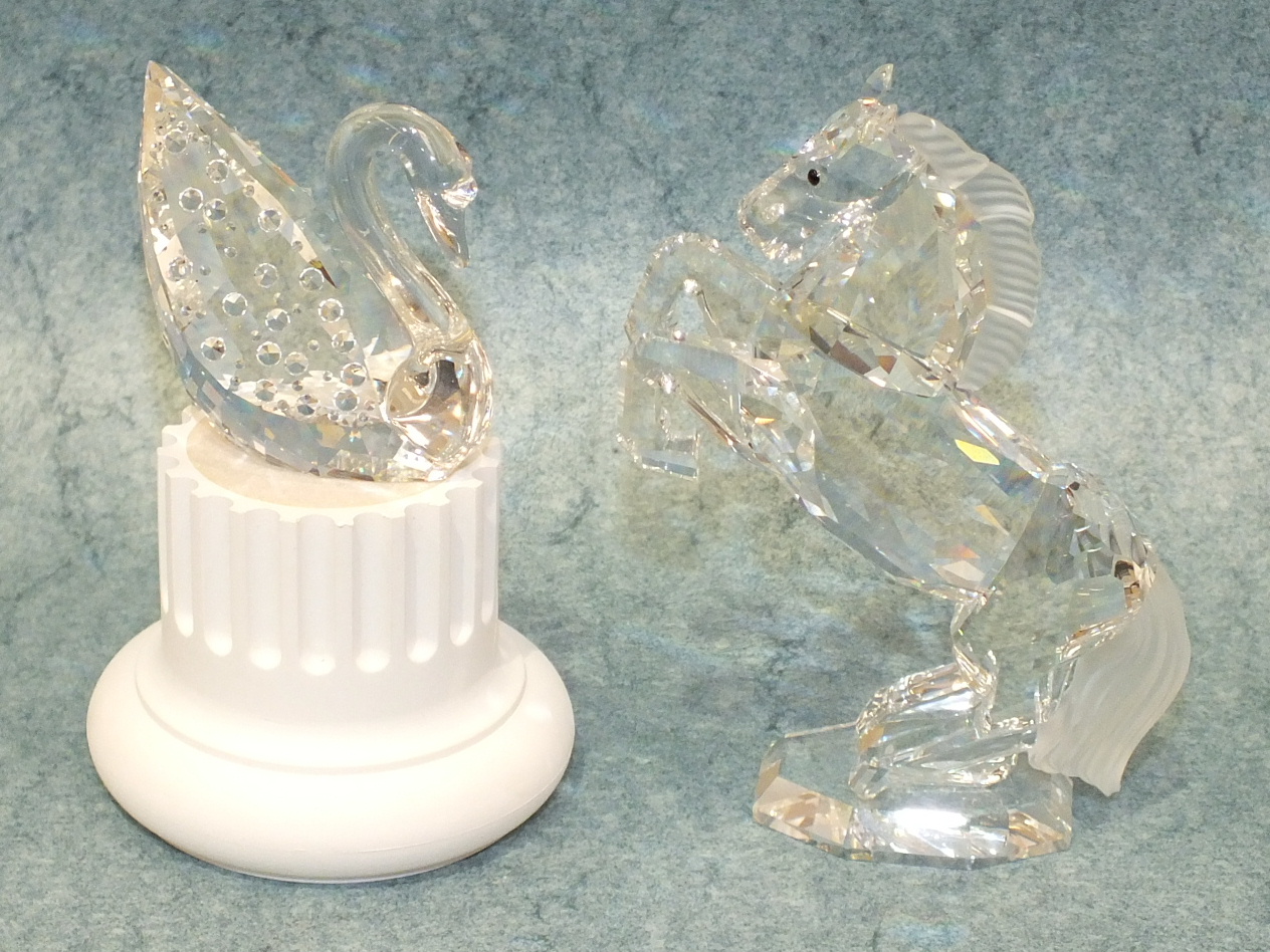 A Swarovski Centenary crystal swan on plinth and a Swarovski rearing stallion, both boxed, (2).