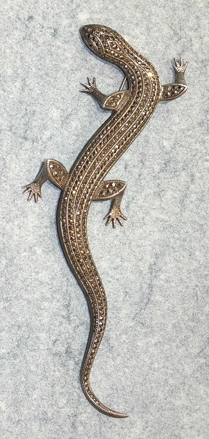 A large silver and marcasite brooch in the form of a lizard, 14.5cm long.