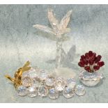 Three Swarovski crystal table ornaments, a palm tree, a vase of roses and a bunch of grapes, all