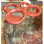 A set of four modern retro-style chrome support rotating bar stools with upholstered seats, (1 a/