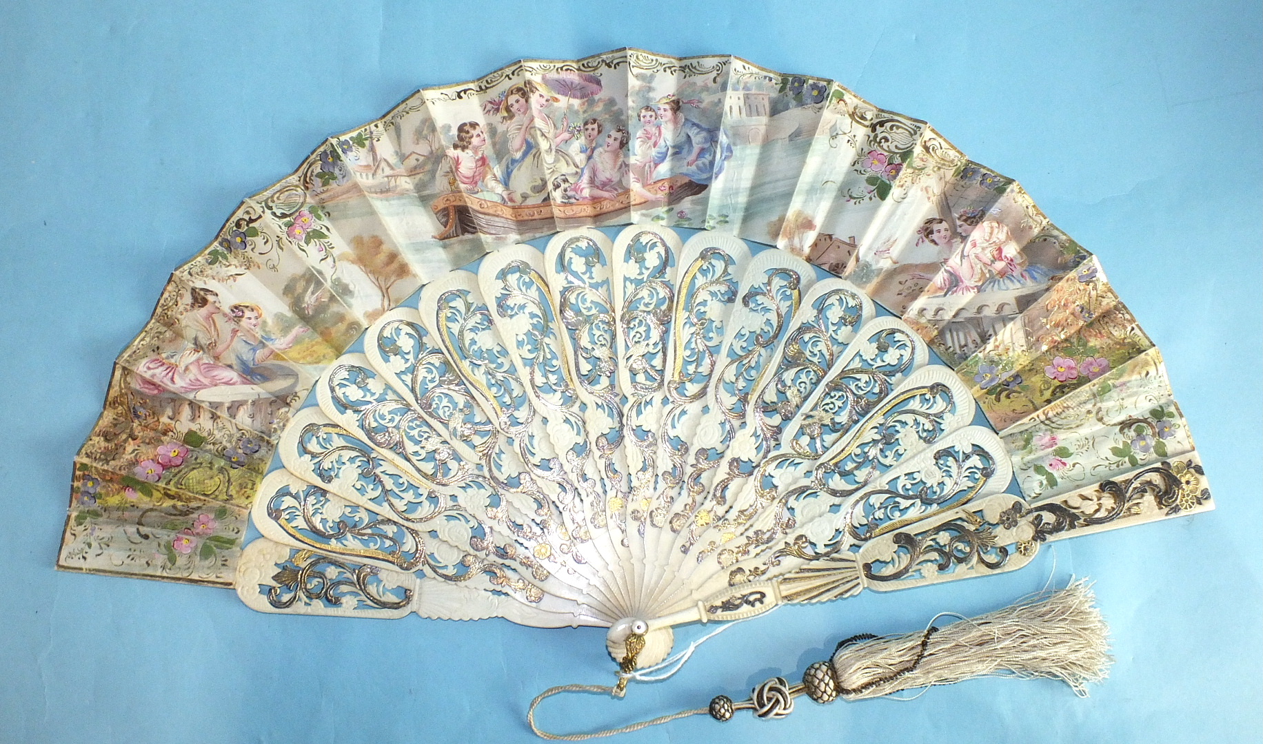 An early-19th century fan, the carved and pierced bone guards and sticks inlaid with metal foils,