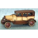 A Distler tinplate clockwork limousine with driver, (no arms), in two-tone cream/brown with orange