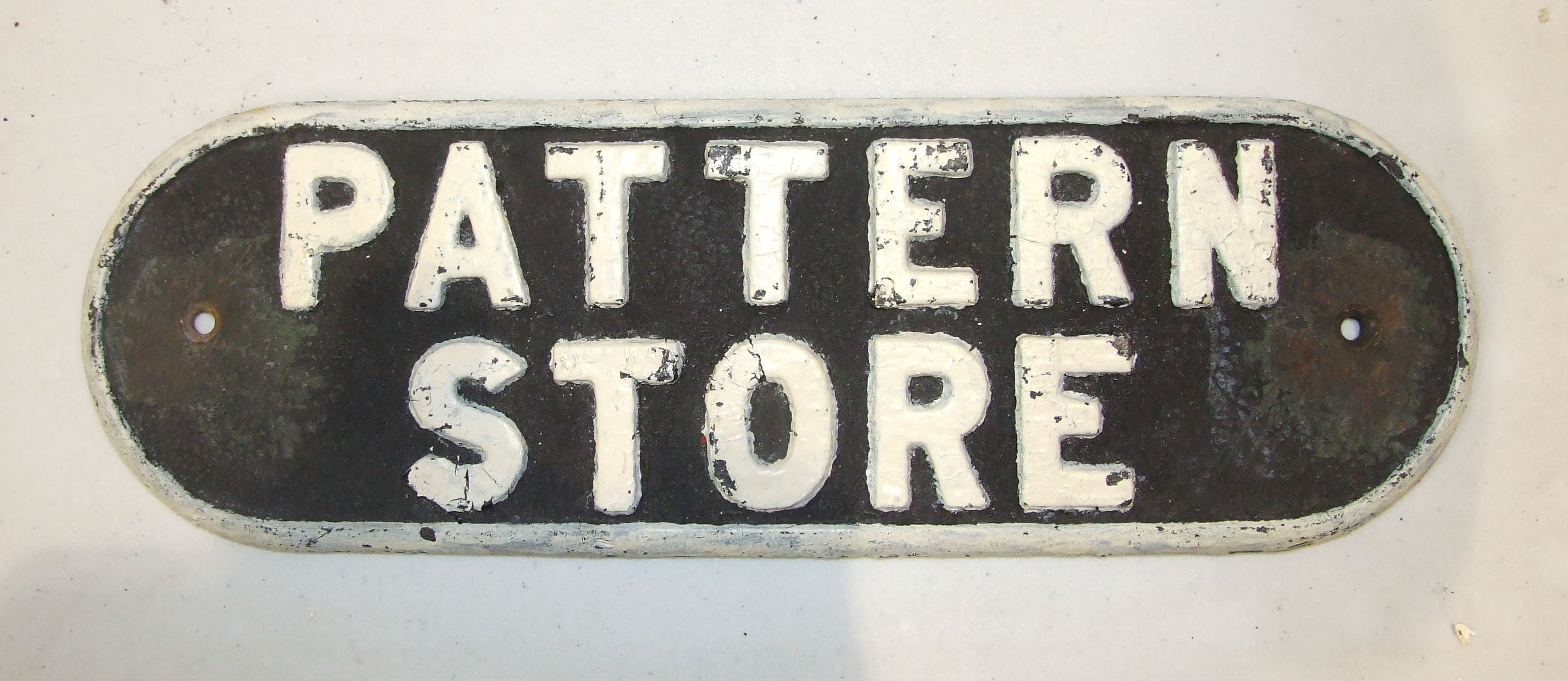 A cast iron LNER door plate "Pattern Store", 13 x 38cm.