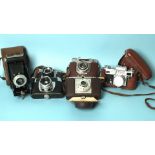 Six cameras: three Halinas, a German Dacora, a Russian Kiev and a Kodak 'Brownie', (6).