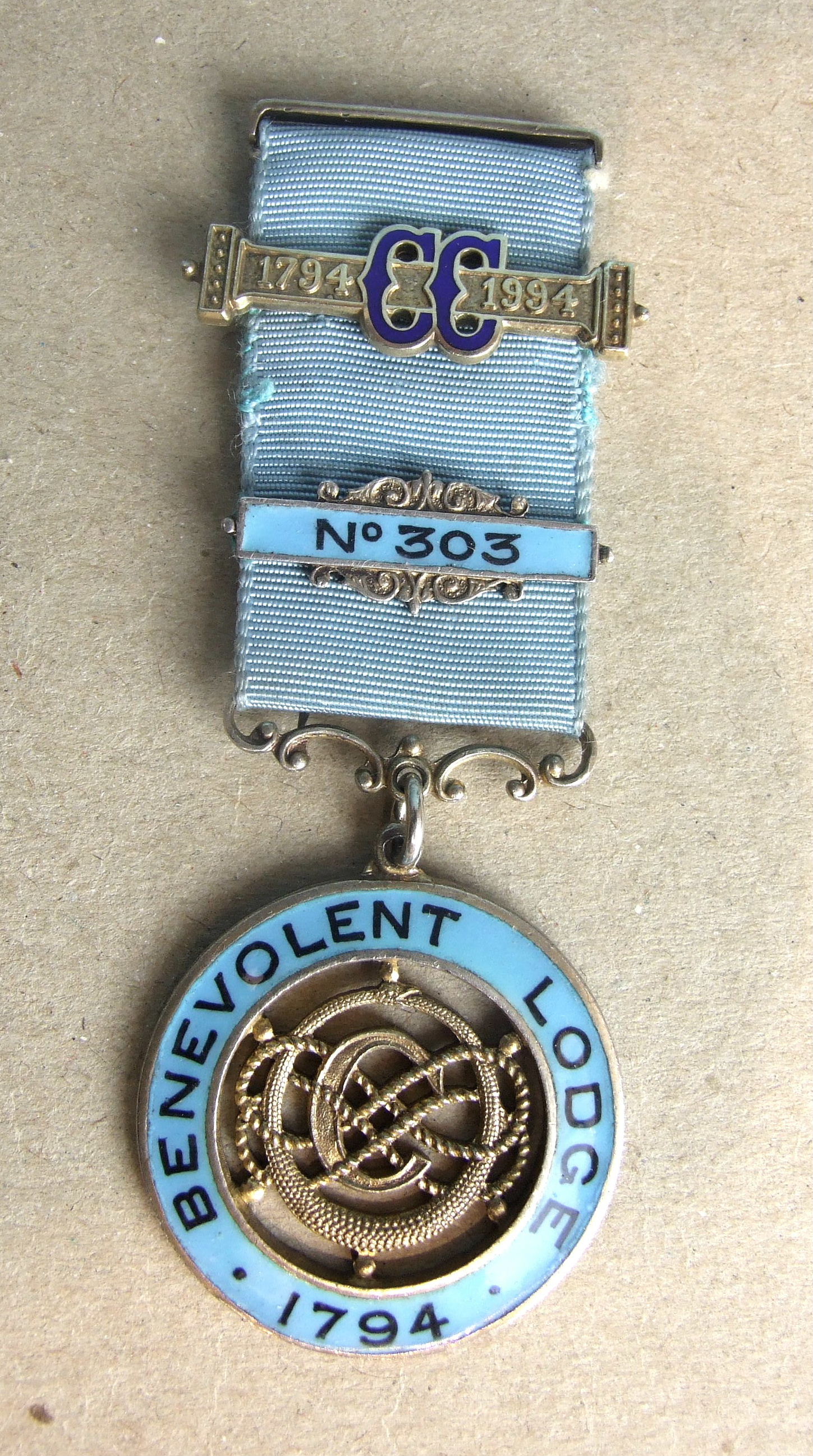 A silver and enamel Centenary jewel for Benevolent Lodge no.303 to Bro. A G Mitchel, by Toye & Co.