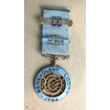 A silver and enamel Centenary jewel for Benevolent Lodge no.303 to Bro. A G Mitchel, by Toye & Co.