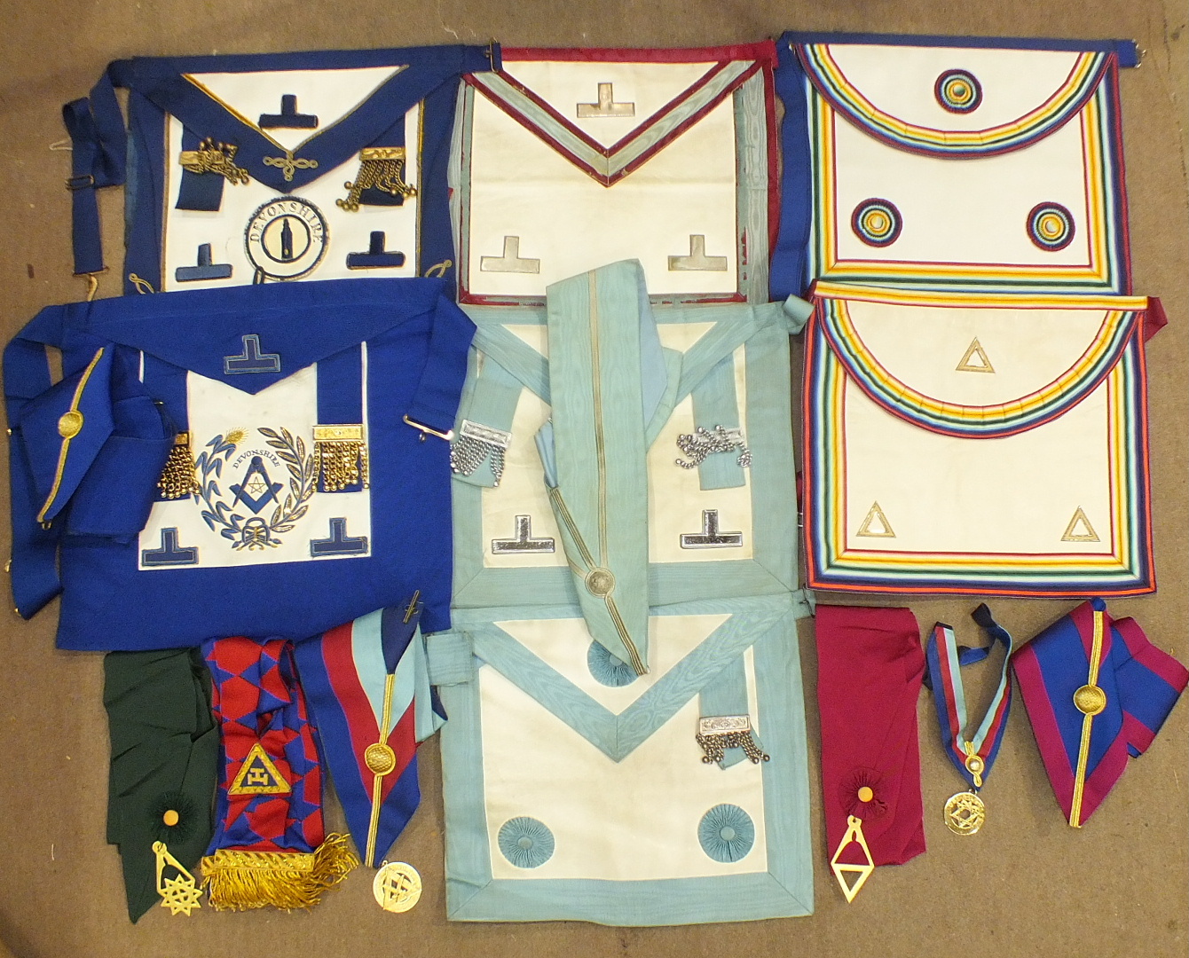 A collection of Craft Masonic regalia including PGM's undress apron, Mark, Ark Mariners and