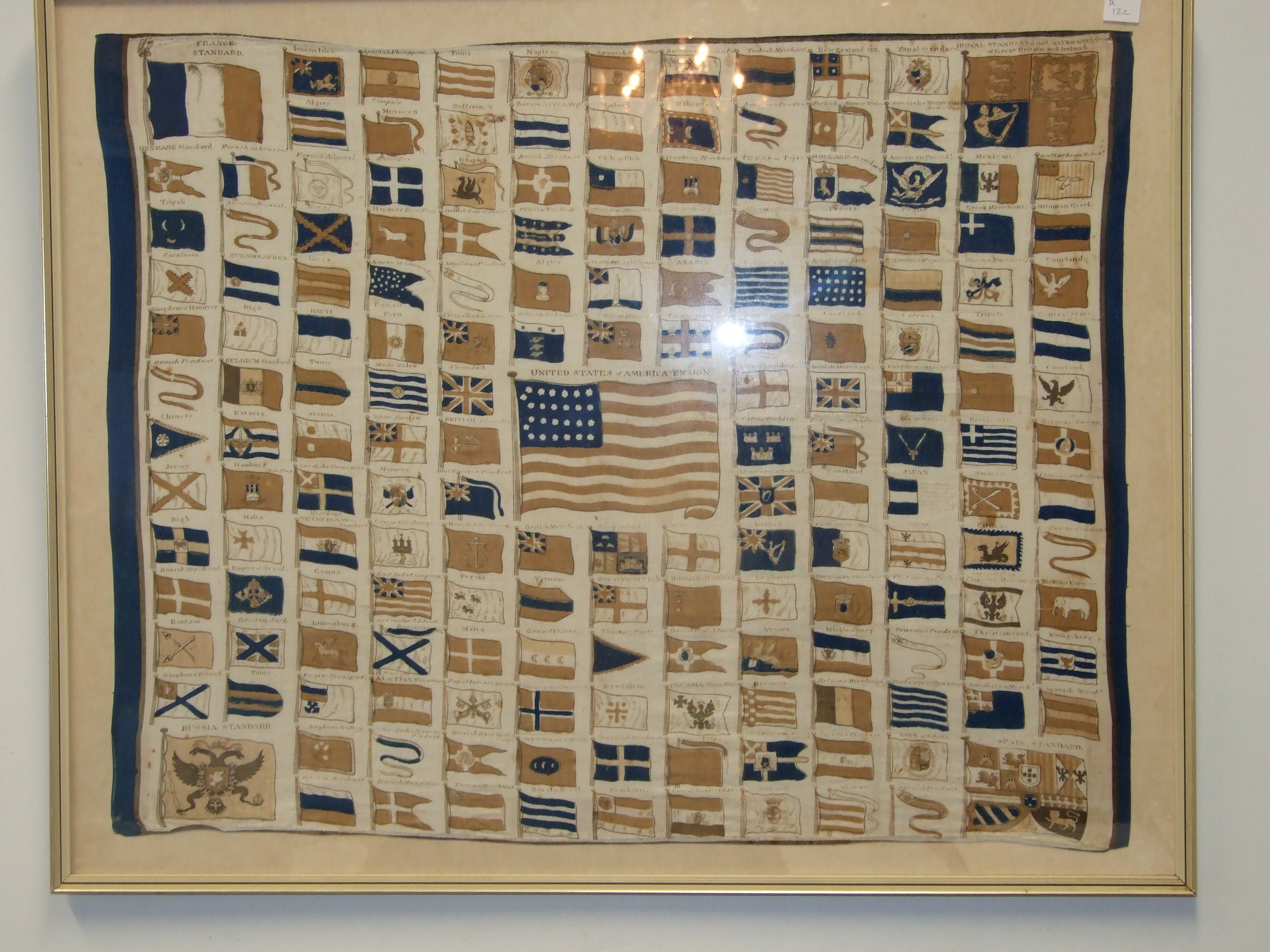 A linen panel printed with naval standards and ensigns of the world with the USA stars and Stripes