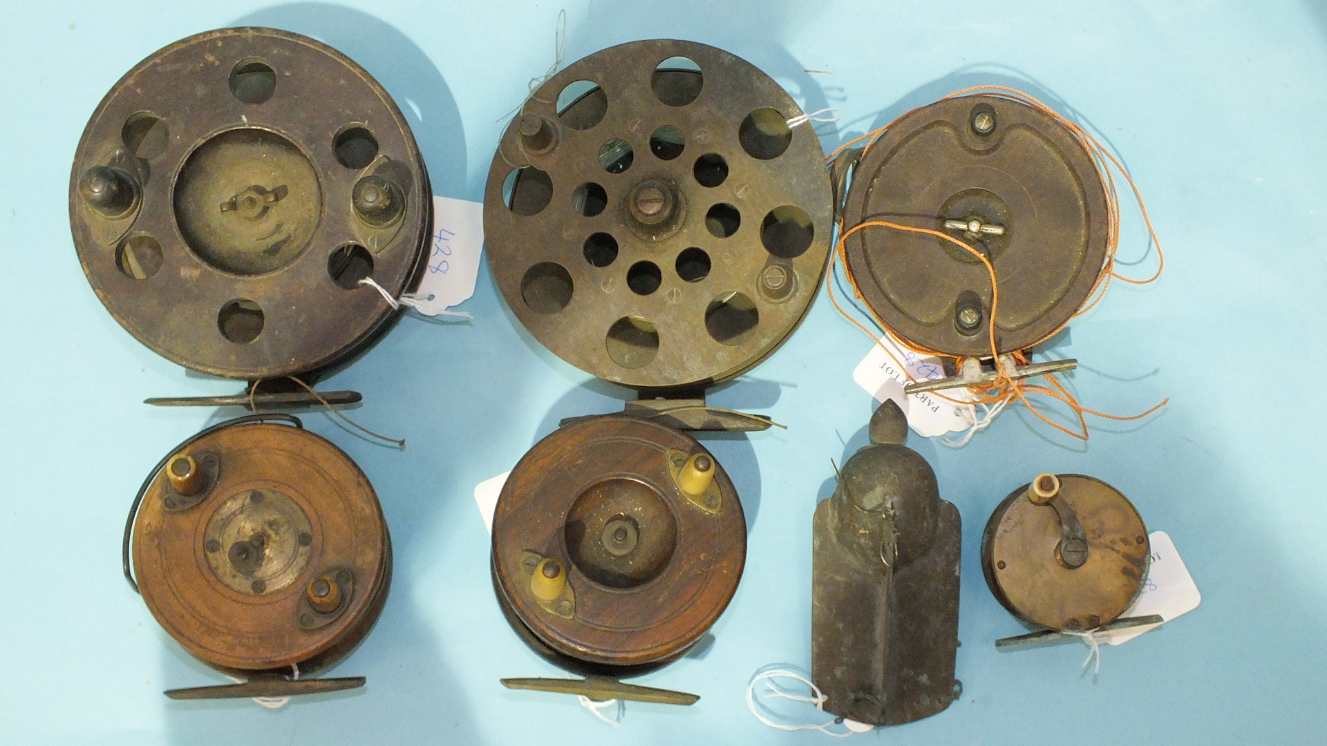 Three 19th century wooden trolling reels, an Alcocks Bakelite reel, a 19th century brass winch and - Image 2 of 4