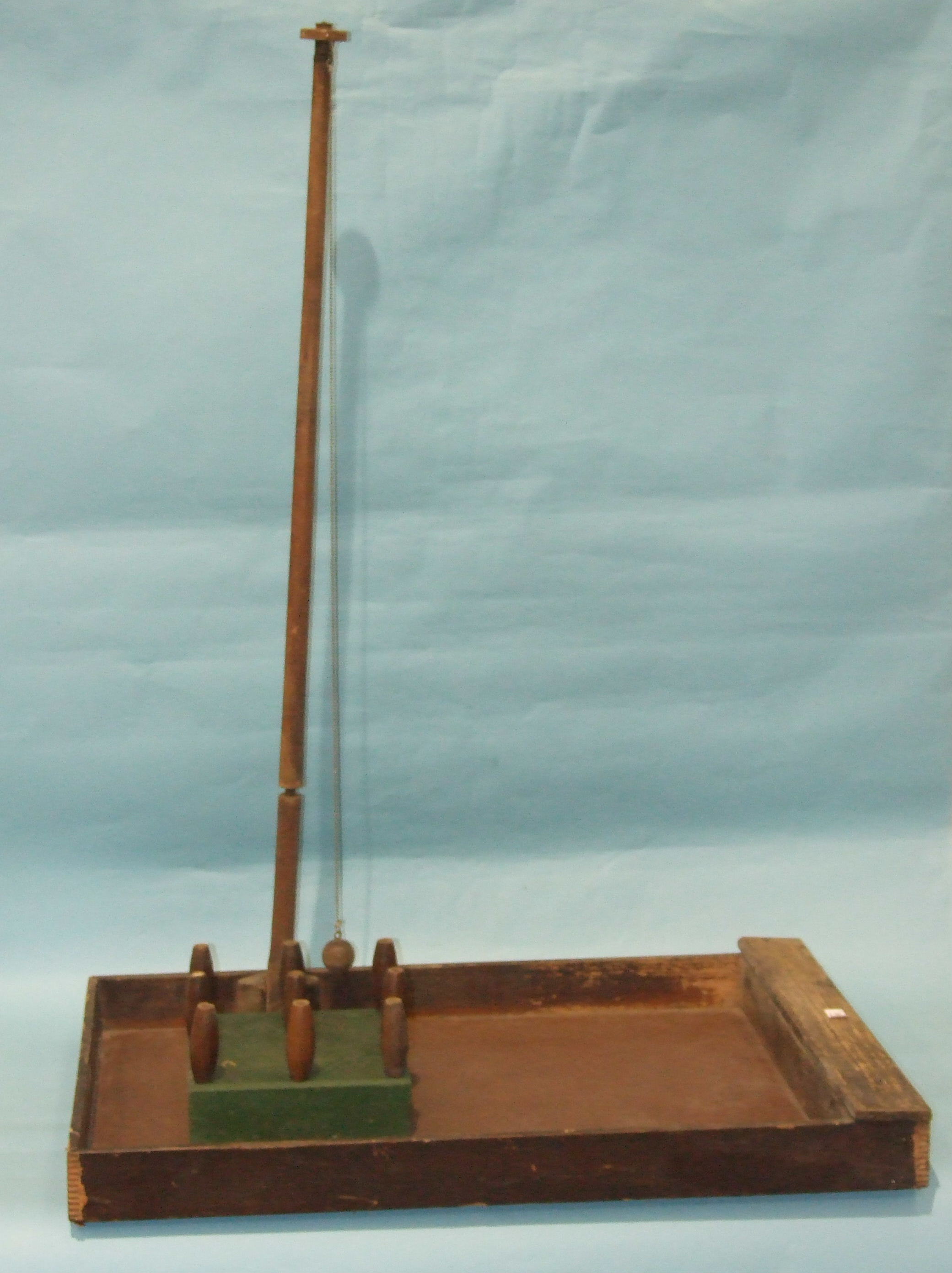 An early-20th century wooden bar skittles table, complete with nine turned wood skittles.