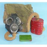 A WWII gas mask no.4A with canvas haversack and no.6 anti-gas ointment.