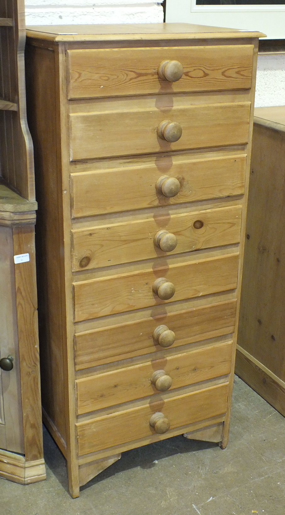 A modern bank of eight pine drawers, 54cm wide, 123cm high.