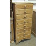 A modern bank of eight pine drawers, 54cm wide, 123cm high.