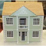 A painted wood dolls house, 60cm wide, 60cm high.