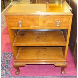 A modern walnut low bookcase, 61cm wide, an oak tea trolley, a Lloyd Loom linen basket and a