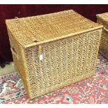 A deep wicker hamper with carrying handles, possibly a log basket, 72cm and other baskets.