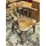 An elm and beech 'Captain's' chair with moulded seat and turned legs.