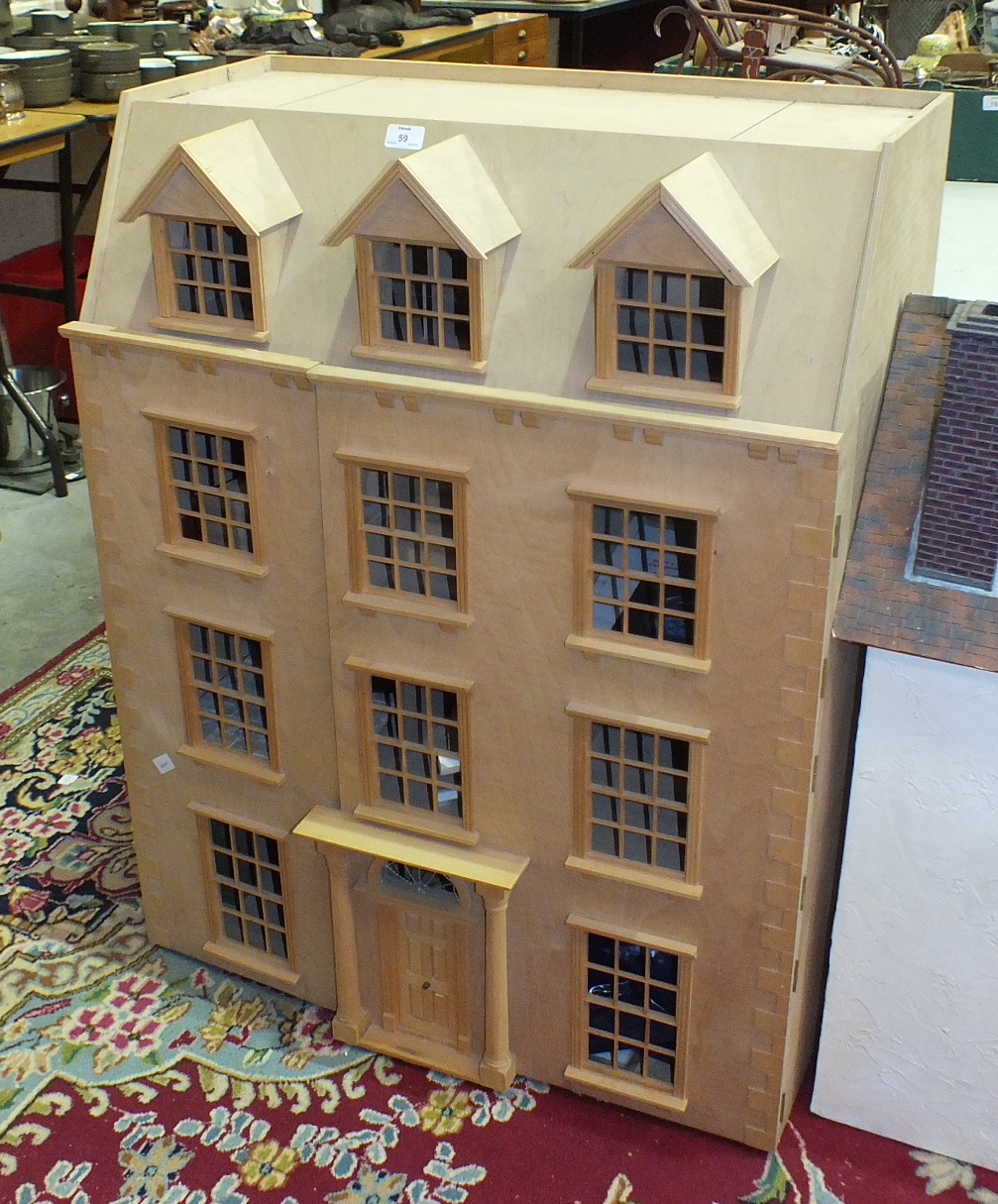 A modern kit-built wooden doll's house, 76cm wide, 98cm high, 39cm deep, one other smaller doll's