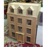 A modern kit-built wooden doll's house, 76cm wide, 98cm high, 39cm deep, one other smaller doll's