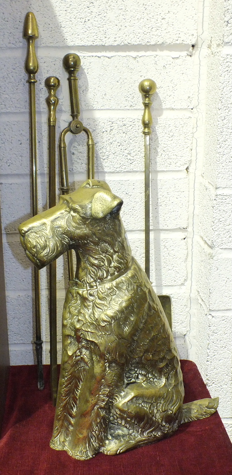 A brass companion set holder in the form of an Airedale Terrier, 42cm high and three fire