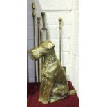 A brass companion set holder in the form of an Airedale Terrier, 42cm high and three fire