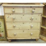 An early-19th century pine rectangular chest of two short and three long drawers, on turned feet,