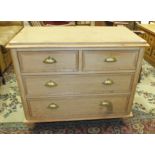 A 19th century pine chest of two short and two long drawers with brass handles, on later turned