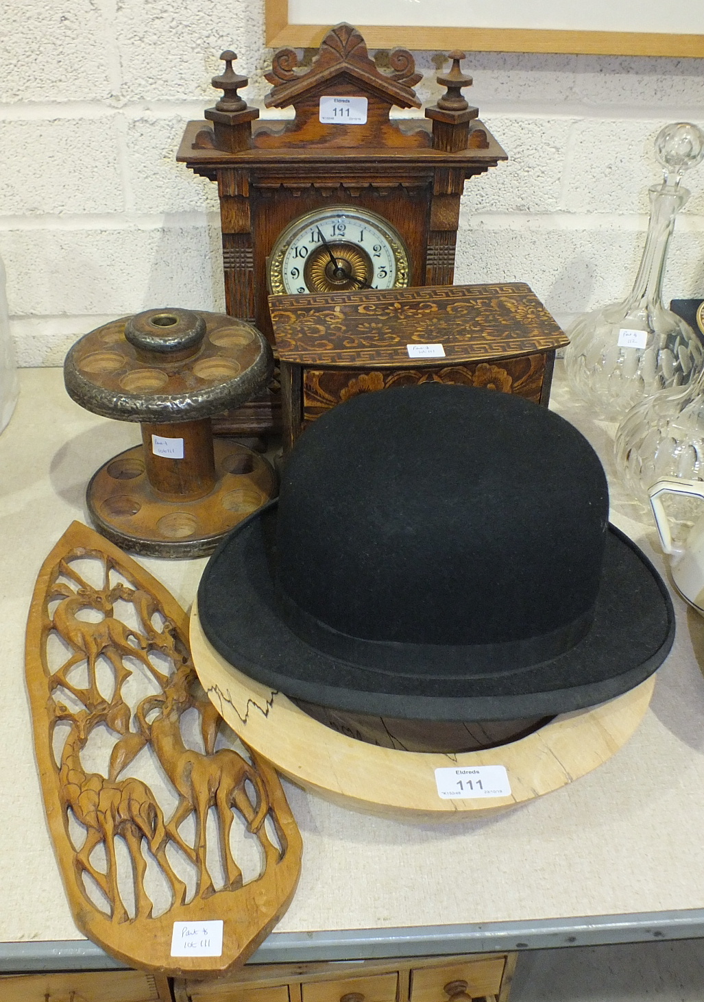 An oak-cased striking mantel clock, 34cm high, a circular metal-mounted wooden two-tier egg holder