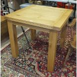 A modern oak dining table with fold-over top, on square legs, 160 x 80cm extended.