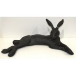 A Suzie Marsh bronzed sculpture of a relaxing hare, 58cm long, 22.5cm high.