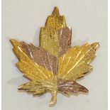 A tri-colour gold maple leaf brooch, indistinctly-marked, 4.3cm long, 8.3g.