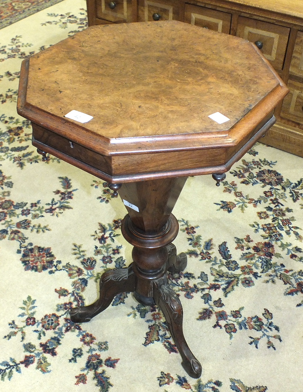 A Victorian walnut octagonal work table with lift lid and fitted interior, on tapered octagonal