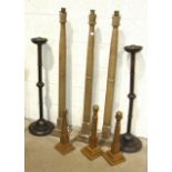 A set of three Masonic turned oak candle holders, 123cm high, two others and three short oak