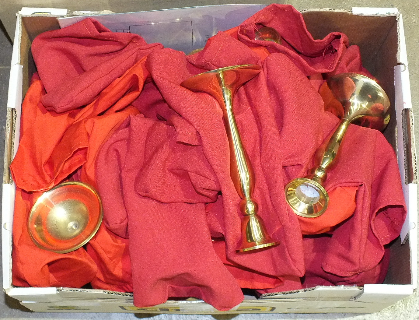 Thirty-three brass altar candlesticks, a box of red candles, artificial roses, veils, etc.