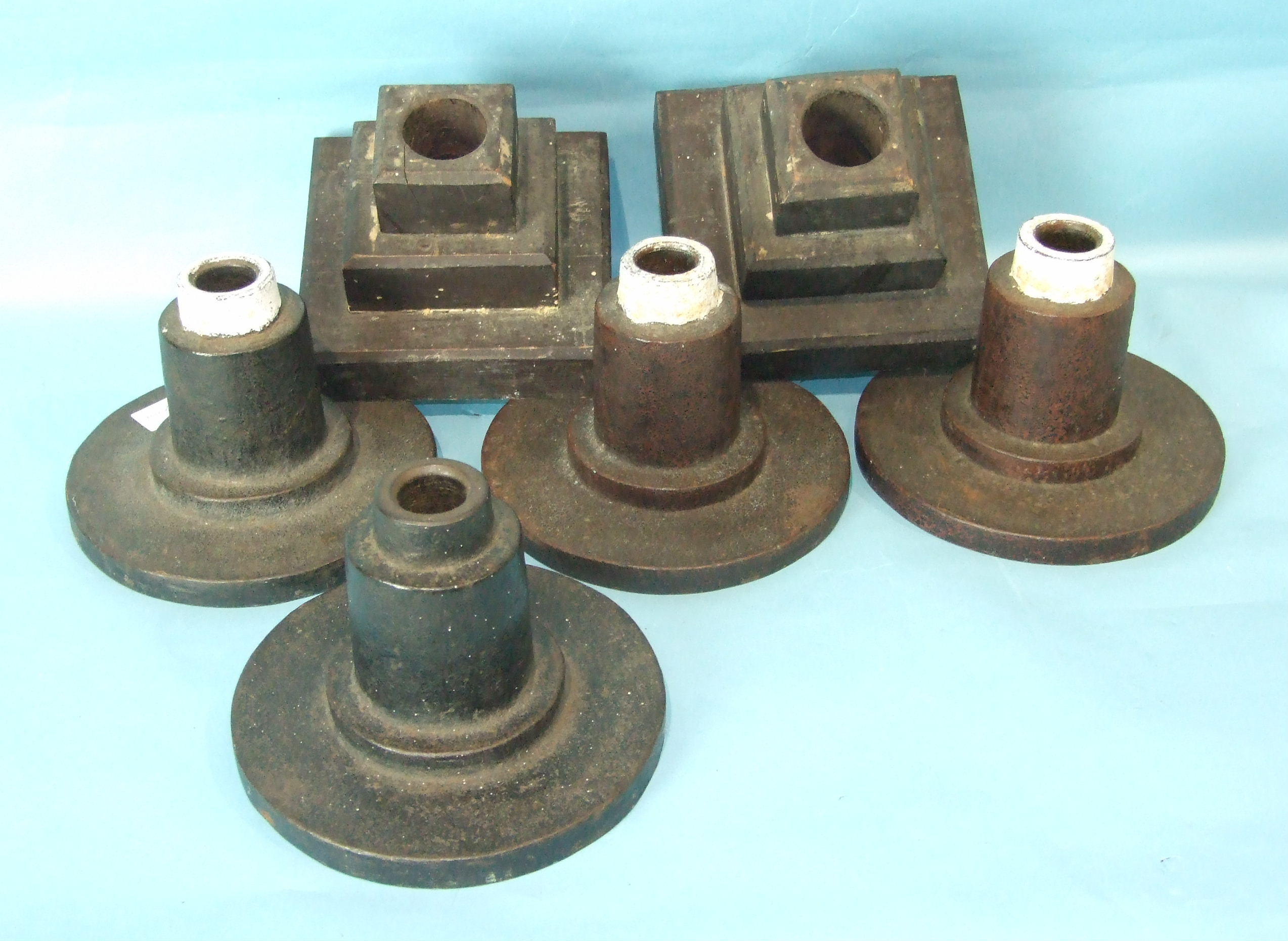 Four cast iron banner or wand stands and two wood banner stands, (6).