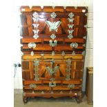 An Oriental 20th century rosewood-veneered two-section cupboard, each section fitted with a pair